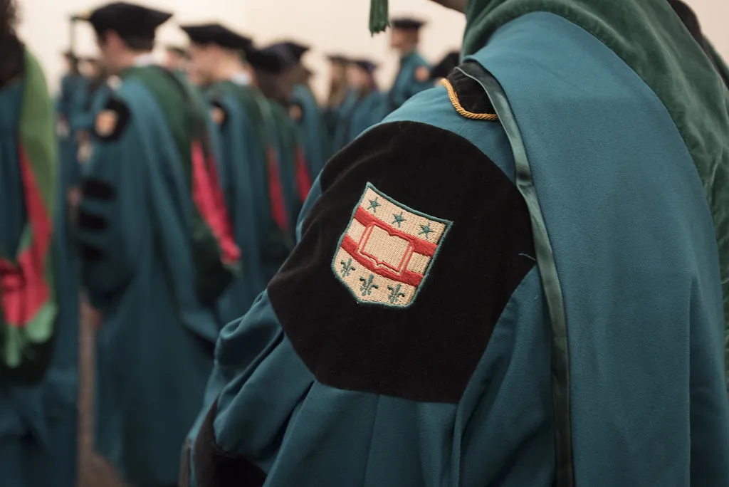 "Zoom in on the shoulder of a WashU Graduate showing the university crest"